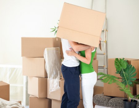 Furniture and boxes being loaded into a van for transport