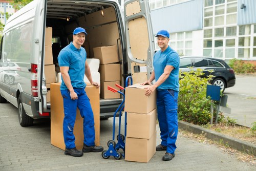 Preparing packed boxes and furniture for a moving van in Woodside