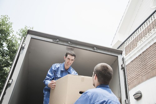 Movers carrying boxes through an apartment hallway in Woodside
