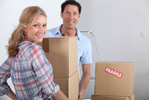 Boxes and furniture being loaded into a local removal van
